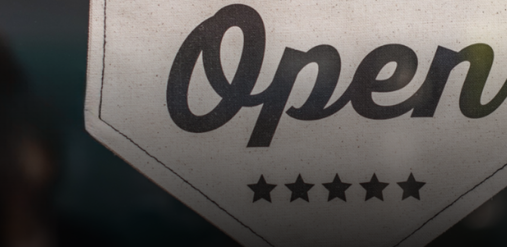 A banner that says the establishment is open