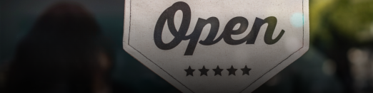 A banner that says the establishment is open