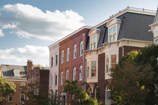 Historic brick buildings under a partly cloudy sky.